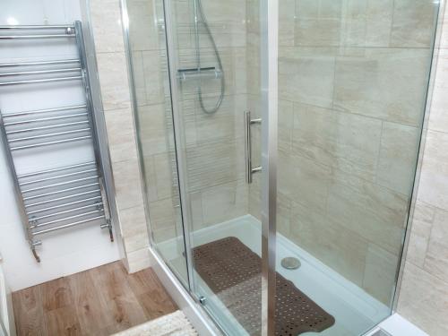 a shower with a glass door in a bathroom at Weymouth Bay Apartment C in Weymouth