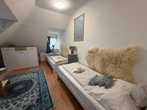 a bedroom with two beds and a teddy bear at Boróka-ház Mohács in Mohács