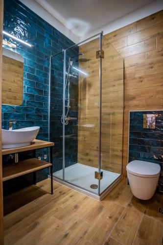 a bathroom with a shower with a toilet and a sink at Apartment Jungle in Belgrade