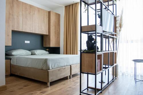 a bedroom with a bed and a book shelf at Apartment Jungle in Belgrade