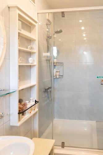 a bathroom with a shower with a glass door at AV villa in Nida