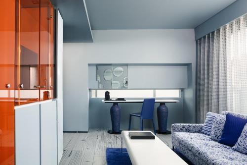 a living room with a couch and a table at Fresh Hotel, a member of Design Hotels in Athens
