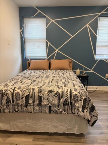a bedroom with a bed with a geometric wall at Cozy Modern Studio in Philadelphia