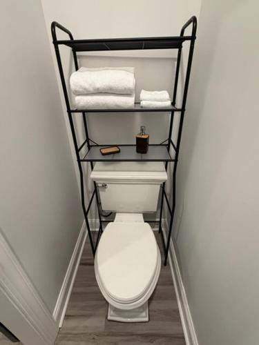 a bathroom with a white toilet and towels at Cozy Modern Studio in Philadelphia