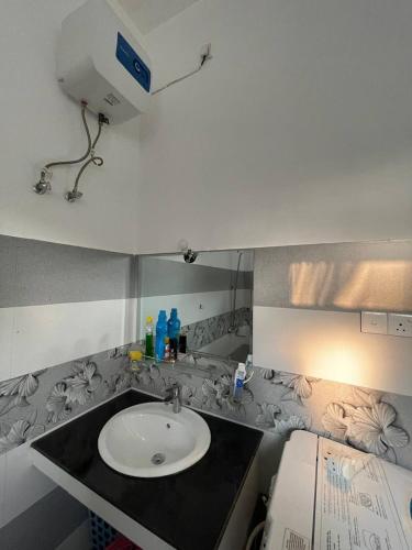 a bathroom with a sink and a counter top at Mayon's Home in Kalutara
