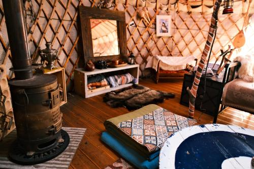 a room with a stove and a map in a yurt at Nomad Yurt, 60 year old in Ryskulovo