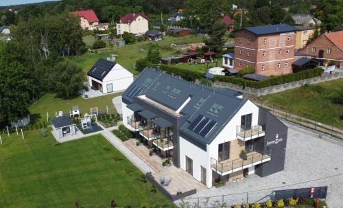 an aerial view of a white house with a blue roof at Jantarnia in Jantar