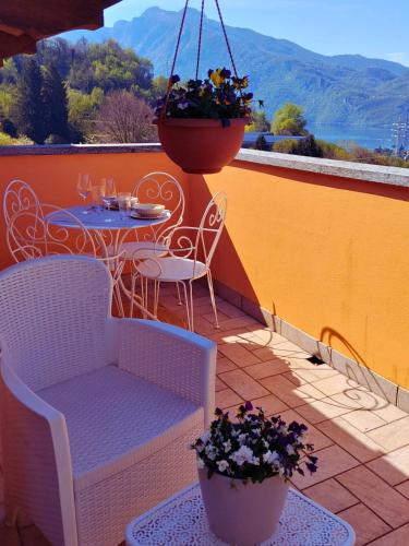 a patio with a table and chairs on a balcony at Larius Apartment - Como Lake View - Free Parking in Mandello del Lario