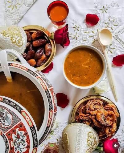 a table with bowls of food and a bowl of soup at Ahmed house in Agadir