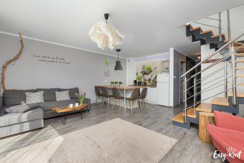 a living room with a couch and a table at Piastowska in Pobierowo