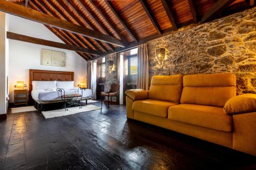 a living room with a couch and a bed at Hotel Emblemático Duque de la Torre in Arona