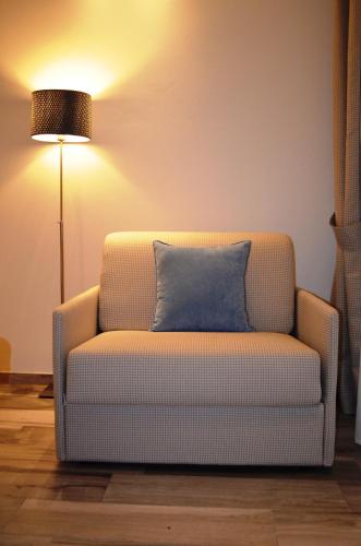 a couch with a blue pillow in a living room at Appartamenti Barzilai in Gabicce Mare
