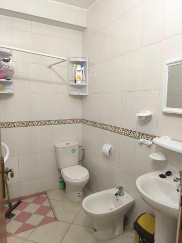 a bathroom with a toilet and a sink at nayla y amira in Martil