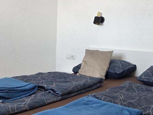 a room with two beds and a pillow on the floor at Cozy Bungalow Stipe in Plitvička Jezera