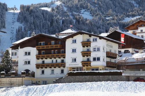 a hotel in a ski resort in the snow at Ritterhof in Fiss