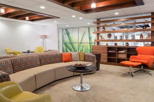 a living room with a couch and a table and chairs at EVEN Hotel Ann Arbor S - University Area by IHG in Ann Arbor
