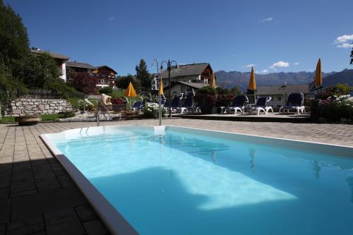 a large blue swimming pool in a yard at Ritterhof in Fiss