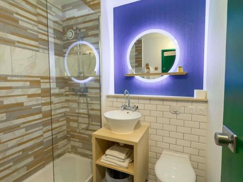 a bathroom with a sink and a glass shower at ibis Styles Paris Hippodrome de Vincennes in Joinville-le-Pont