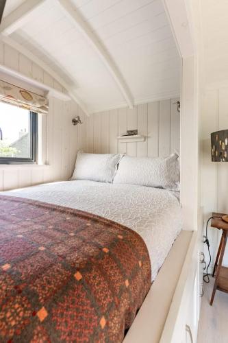 a bedroom with a large bed in a room at Unique Double Shepherd's Hut Hideaway - Pembrokeshire in Haverfordwest