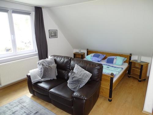 a living room with a couch and a bed at DZ 11 Doppelzimmer in Heringsdorf