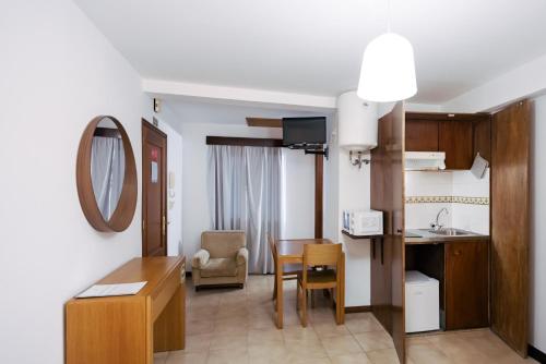 a room with a kitchen and a dining room at Murças74 - Studio Apartments in Funchal