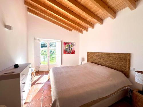 a bedroom with a bed and a window at Marvão Country Houses - Queixos I in Santo António das Areias