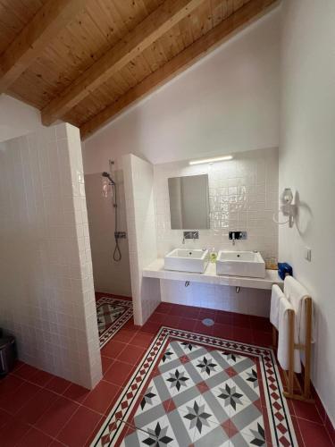 a bathroom with two sinks and a mirror at Marvão Country Houses - Queixos I in Santo António das Areias