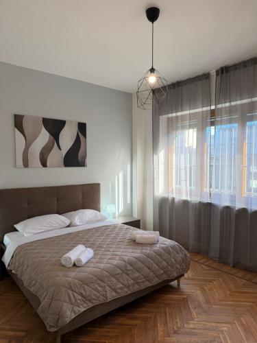 a bedroom with a bed with two towels on it at AlexBnB in Turin