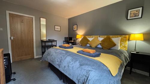 a bedroom with a large bed with two pillows on it at Ardenbeg in Grantown on Spey