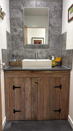 a bathroom with a sink and a mirror at Ardenbeg in Grantown on Spey