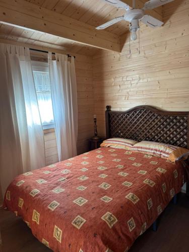 a bedroom with a large bed in a wooden room at El Palmito Rural Home in Jerez de la Frontera