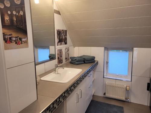 a bathroom with a sink and a mirror at Ferienhaus Heilhecker in Brake