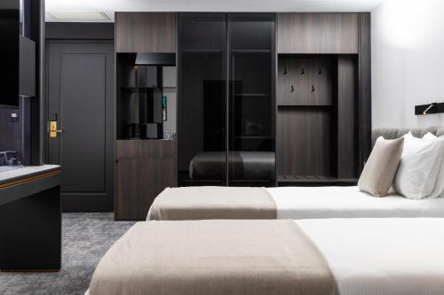 a hotel room with two beds and a sink at Central Hotel in Ferizaj