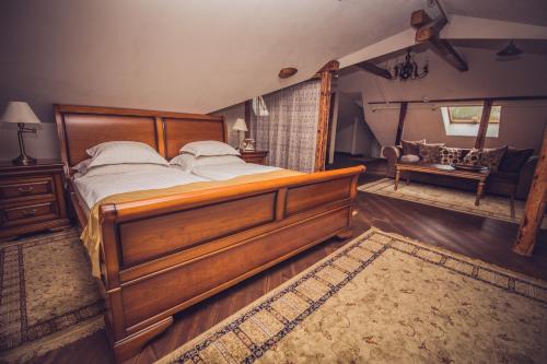 a bedroom with a large wooden bed with white pillows at Villa Margaretha Boutique Hotell in Tartu