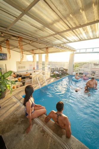 a group of people sitting in a swimming pool at Hotel San Francisco in Tarapoto