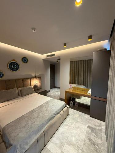 a large bedroom with a large bed and a tub at The Pilgrim Ephesus Hotel in Selçuk