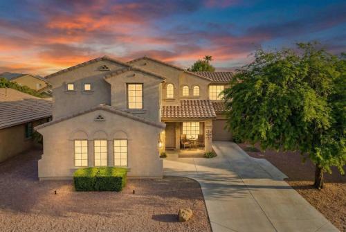 a large house with a tree in front of it at Pool Grill Games Chill - Surprise Awaits in Surprise