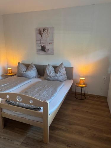 a large bed in a room with two lamps at Ute Urbaner in Irschen