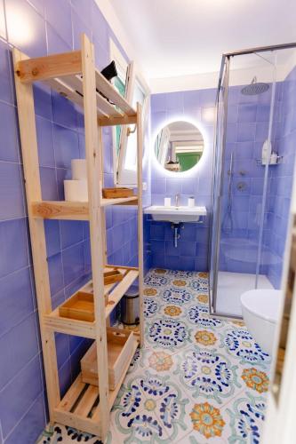 a bathroom with a blue tiled floor at Villetta La Conca in Conca dei Marini