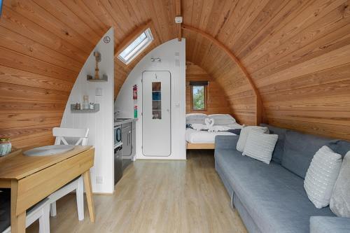 a living room with a couch and a bedroom at Lakeside Nest - Fishing Lakes, Heated Outdoor Swimming Pool 500yrds on Sister Park , Pool Open May to September in Exeter