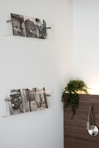 a room with two pictures on the wall and a plant at Downtown Skyloft in Kalamata