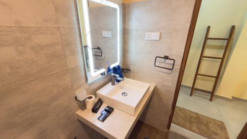 a bathroom with a sink and a mirror at Thambapanni Villa in Unawatuna
