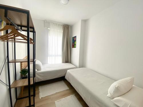 a room with two bunk beds and a ladder at Apartamento A pie de Playa in Miño