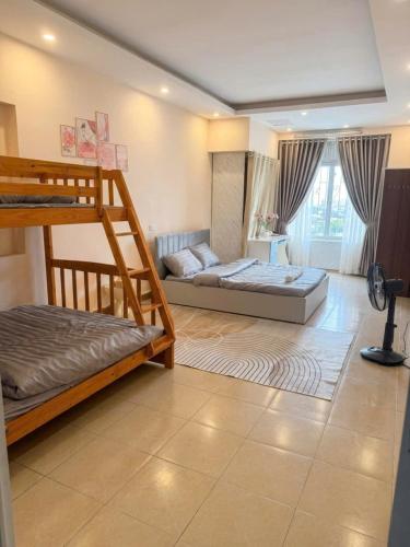 a bedroom with two bunk beds and a living room at Hanoi Amie Duplex Homestay in Hanoi