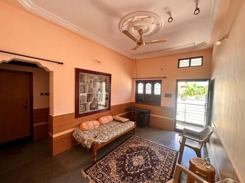 a living room with a couch and a window at Sri Devi Krupa in Hubli