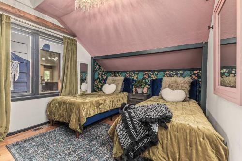 a bedroom with two beds and a purple ceiling at The Disco Chalet in Steamboat Springs