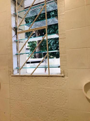 a window in a room with a person looking out at Corfield in Durban