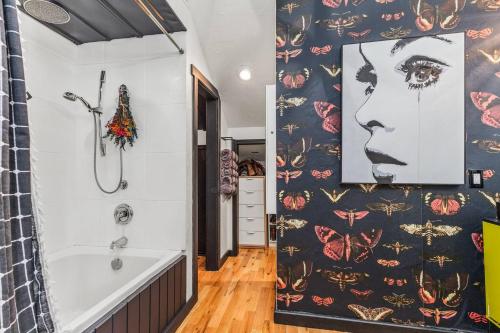 a bathroom with a shower and a bathtub with a patterned wall at The Disco Chalet in Steamboat Springs