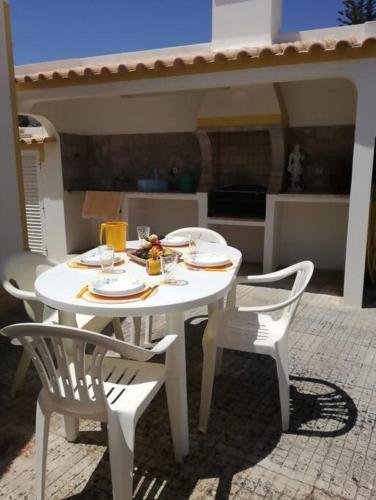 a white table and two chairs with food on it at Spacious House in Sagres with Private Patio & BBQ in Sagres