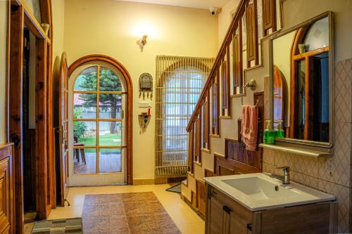 a bathroom with a sink and a large window at White House By Kulut in Shamshi